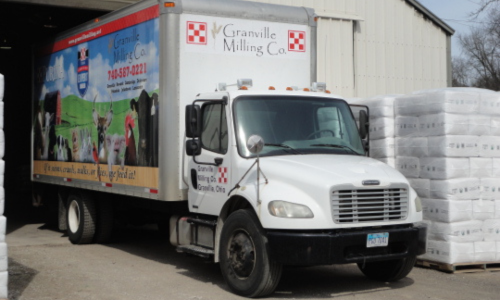 Granville Milling Co. delivery truck parked in a garage