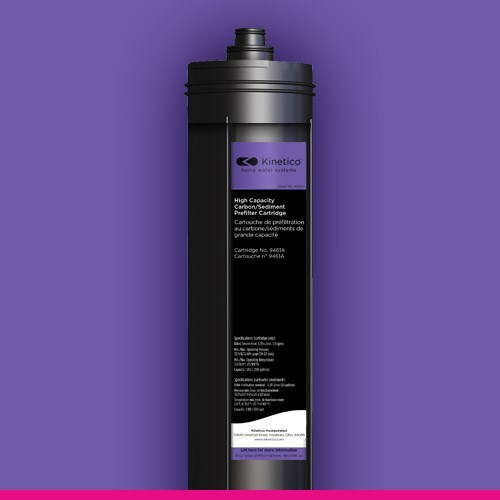 Tall black water filter cartridge with a label featuring text and the Kinetico logo, set against a purple background, conveying a sleek and modern design.