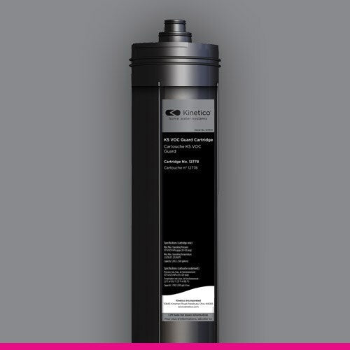 A black water filter cartridge with a matte finish against a gray background. It features the Kinetico logo and technical details on a white label.